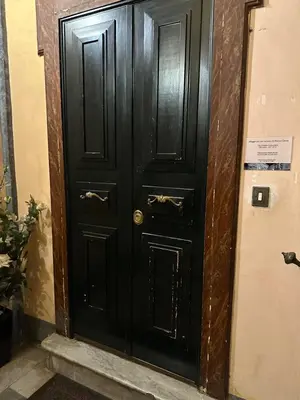 a black door in a hallway with a sign on it at Apt Aurea Luxury Pantheon View in Rome