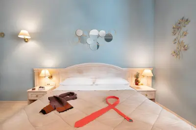 a bedroom with a bed and a sink and a tub at Piccolo Imperiale in Rome