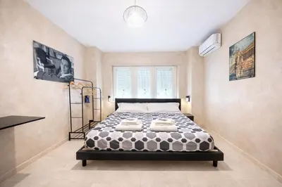 a room with a blue chair and a painting on the wall at Appio Rooms Haven in Rome