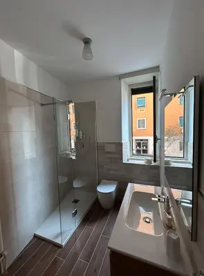 a bathroom with a shower and a sink and a toilet at GeNa Home, a due passi da San Giovanni in Rome