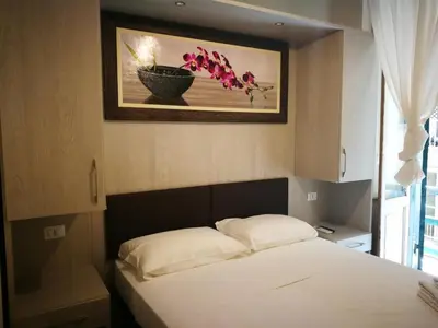 a bedroom with a bed with a painting on the wall at IL Sole in Rome