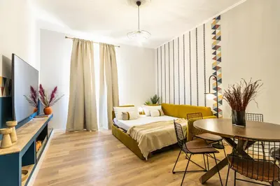 a bedroom with a bed and a table and chairs at Collection39 Scipioni Luxury Apartment in Rome