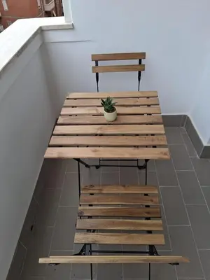 a wooden picnic table with a potted plant on it at Golden Suite in Rome