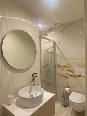 a bathroom with a sink and a toilet and a mirror at Golden Suite in Rome