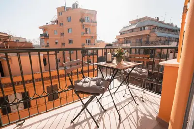 a balcony with a table and chairs on a balcony at La Perla dell'Appia in Rome