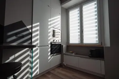 a kitchen with a refrigerator and a window at La Perla dell'Appia in Rome