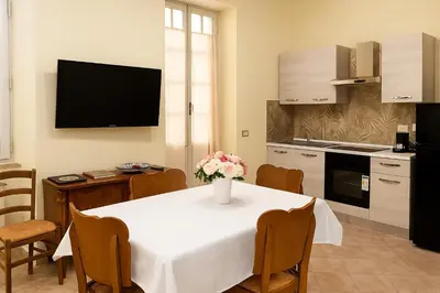 a kitchen with a table with a vase of flowers on it at Colosseo Rooms Apartments in Rome