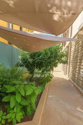 a hallway of a building with a tree and plants at Colosseo Rooms Apartments in Rome