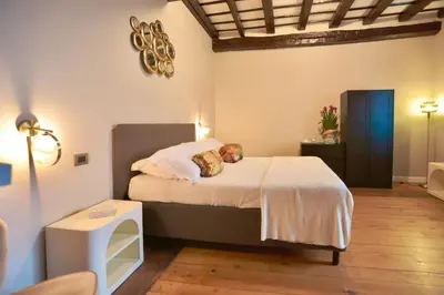 a bedroom with a bed with two teddy bears on it at Biscione Dream Campo de'Fiori in Rome