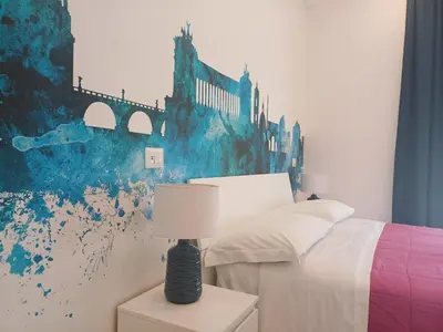 a bedroom with a bed and a painting on the wall at Lux Urbis Pio VIII in Rome