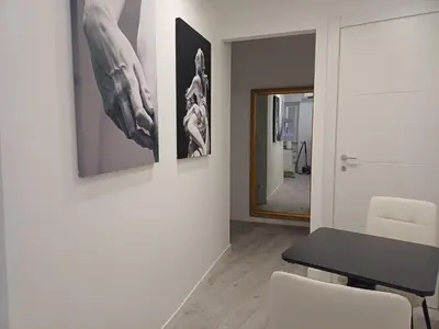 a dining room with a table and a mirror at Lux Urbis Pio VIII in Rome