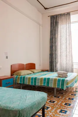 a bedroom with two beds and a window at PP Stanza Privata in Appartamento Pigneto in Rome