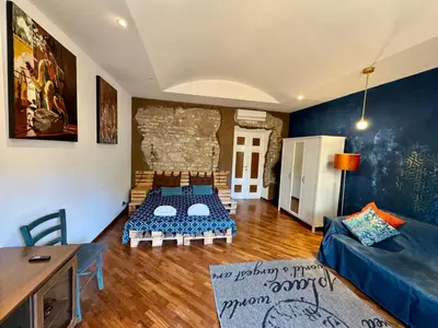 a bedroom with a bed and a window and a television at Argilla Apartment in Rome