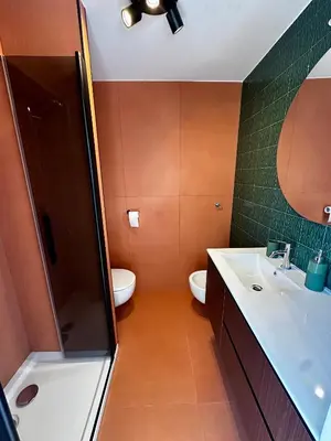 a bathroom with a sink and a toilet at Ai Parrocchetti, Loft con Terrazza Panoramica in Rome