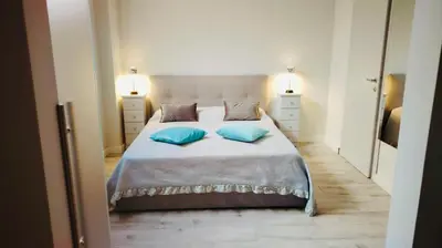 a bedroom with a bed with two blue pillows at Charme Holidays San Saba in Rome