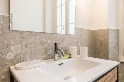 a bathroom with a white sink and a mirror at APT ROME - Guest House Casini 6 Trastevere in Rome