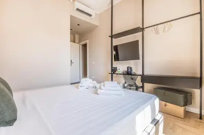 a bedroom with a large white bed with towels on it at APT ROME - Guest House Casini 6 Trastevere in Rome