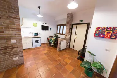 a kitchen and dining room with a tile floor at wonderful apartment in Rome