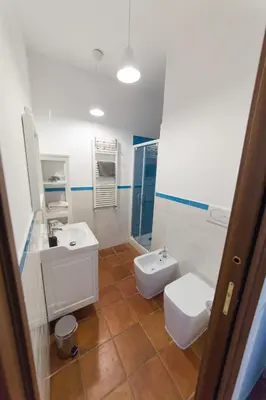 a bathroom with two sinks and a toilet at wonderful apartment in Rome