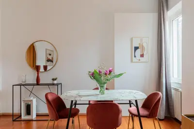 a dining room with a table and chairs and a mirror at iFlat Spanish Steps Chic & Warming Hideaway in Rome