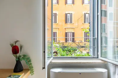 a window with a view of a building at iFlat Monti Charming & Cozy Apt by the Colosseum in Rome