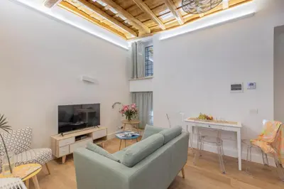 a living room with a couch and a tv at iFlat Monti Charming & Cozy Apt by the Colosseum in Rome