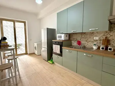 a kitchen with a stainless steel refrigerator and a counter at Domus Basilica San Paolo in Rome