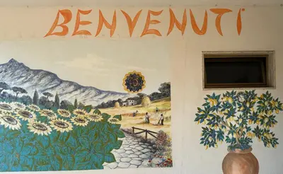 a mural of a field of sunflowers on a wall at Casa per Ferie Eden Cusmano in Rome
