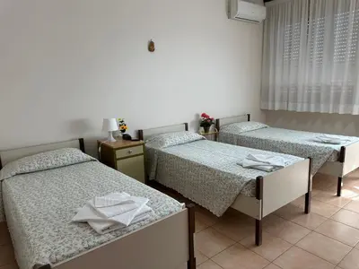 a room with three beds with towels on them at Casa per Ferie Eden Cusmano in Rome