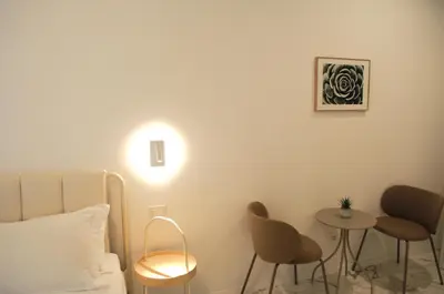 a room with a bed and two chairs and a table at Le Dimore del Duca in Rome