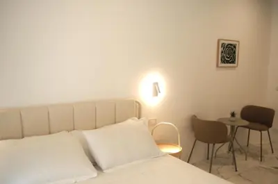 a bedroom with a bed and a table and chairs at Le Dimore del Duca in Rome