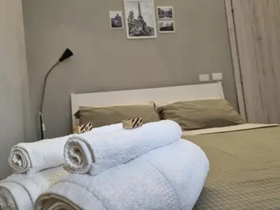 a bedroom with a bed with towels on it at Monolocale luminoso vicino Trastevere in Rome