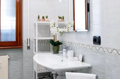 a kitchen with black cabinets and a sink at Modern Apartment near Vatican & Foro Italico - Rome in Rome