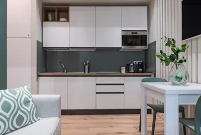 a kitchen with white cabinets and a table at Casa Bressan in Rome