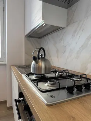 a tea kettle sitting on top of a stove in a kitchen at Giorgi House in Rome