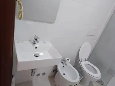 a white bathroom with a sink and a toilet at Euromoon in Rome