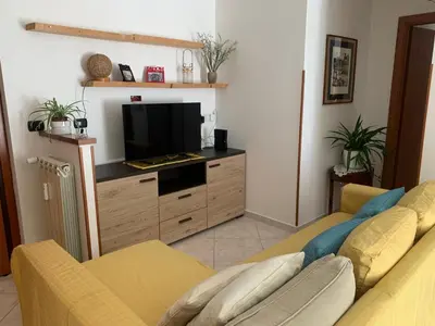 a living room with two couches and a flat screen tv at Lilly's Apartment a 5 minuti Metro C in Rome