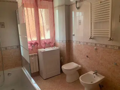 a bathroom with a toilet and a sink at Lilly's Apartment a 5 minuti Metro C in Rome