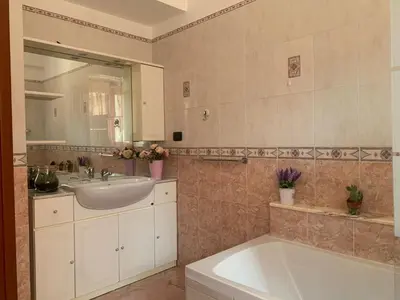 a bathroom with a tub and a sink and a mirror at Lilly's Apartment a 5 minuti Metro C in Rome