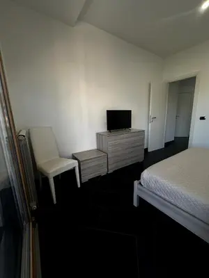 a bedroom with a bed and a desk and a chair at Dimora Battistini in Rome