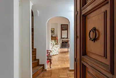 a hallway with a door leading to a living room at GuestHost - Historic Center Apartment Lungotevere in Rome