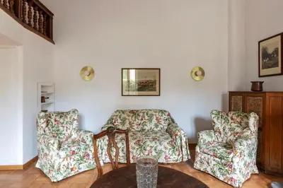a living room with two chairs and a table at GuestHost - Historic Center Apartment Lungotevere in Rome