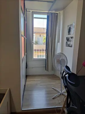 a view of a room with a window and a fan at camera singola al Pigneto in Rome