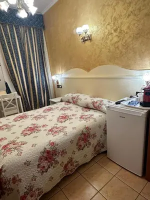 a bedroom with a bed with a floral bedspread at Near Termini station in Rome