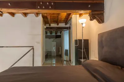 a bedroom with a bed and a ceiling with beams at Navona award Collection in Rome