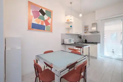 a kitchen with a table and chairs in a room at Apt at Tiburtina Station Free WiFi e Netflix in Rome
