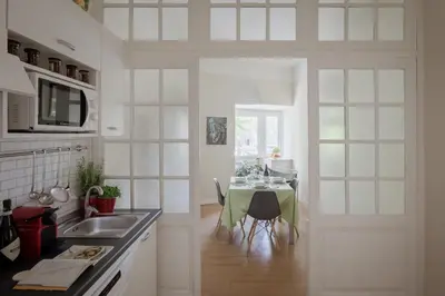 a kitchen with a table and a dining room at Tiber Island View - Trastevere, Campo de' Fiori in Rome