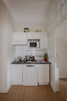 a kitchen with white cabinets and a counter top at Tiber Island View - Trastevere, Campo de' Fiori in Rome