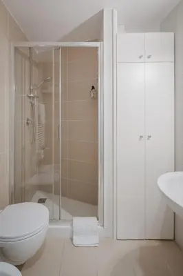 a bathroom with a shower and a toilet and a sink at Tiber Island View - Trastevere, Campo de' Fiori in Rome