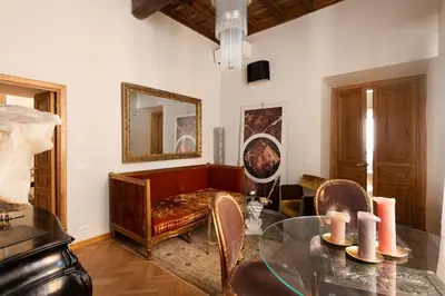 a living room with a glass table and a couch at Idyllia - Luxury home with terrace in Rome